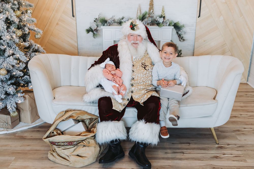 Cozy holiday scene with family members sitting on white couches by a decorated Christmas tree in a bright living room.