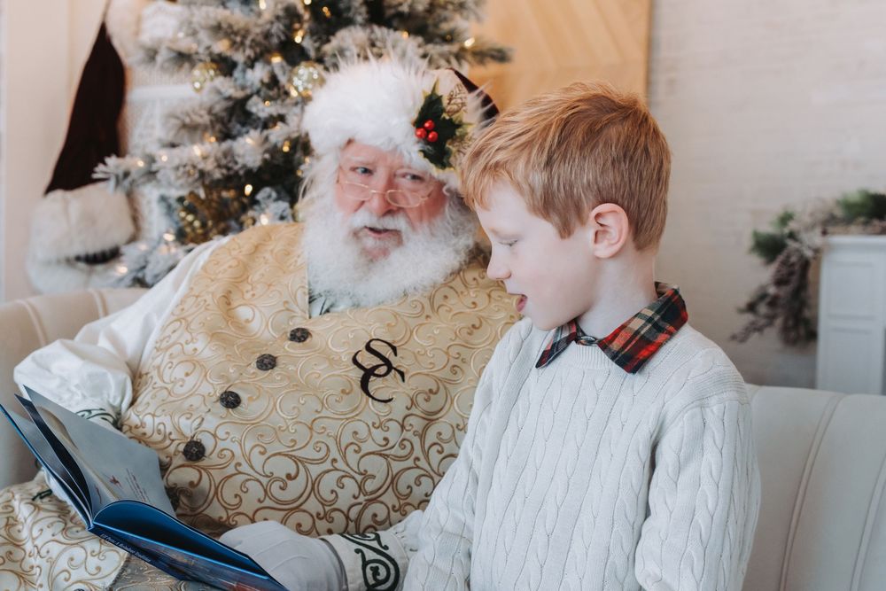 A festive holiday scene with a decorated Christmas tree and someone wearing a white knit sweater in conversation.