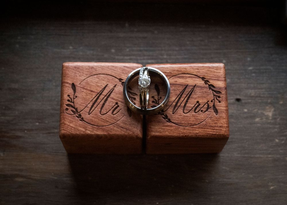 Rustic wooden box with decorative carving and metal hardware photographed from multiple angles.