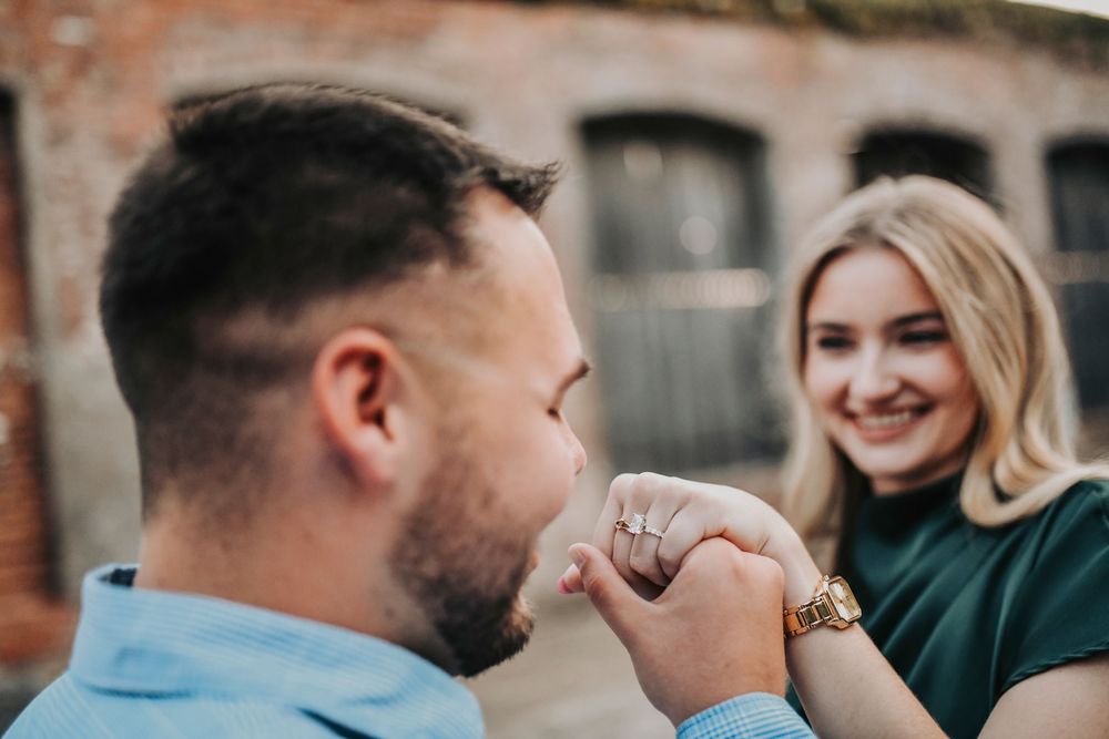 Couple celebrating after proposal at Cotton Mill McKinney before romantic dinner