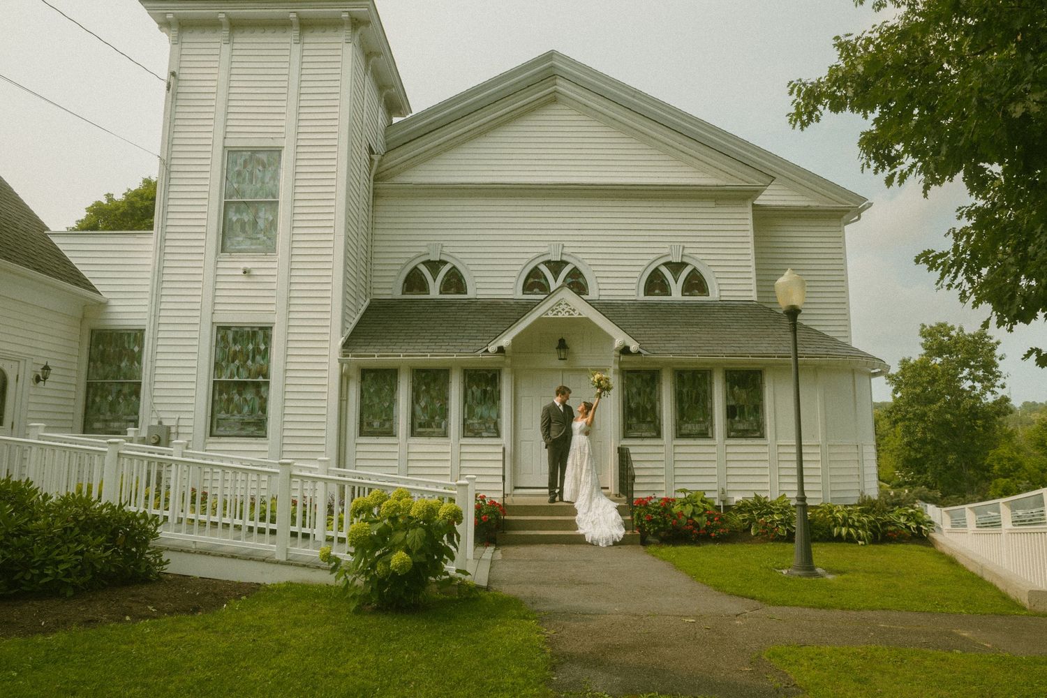 White church building exterior with classic architectural details and landscaping.
