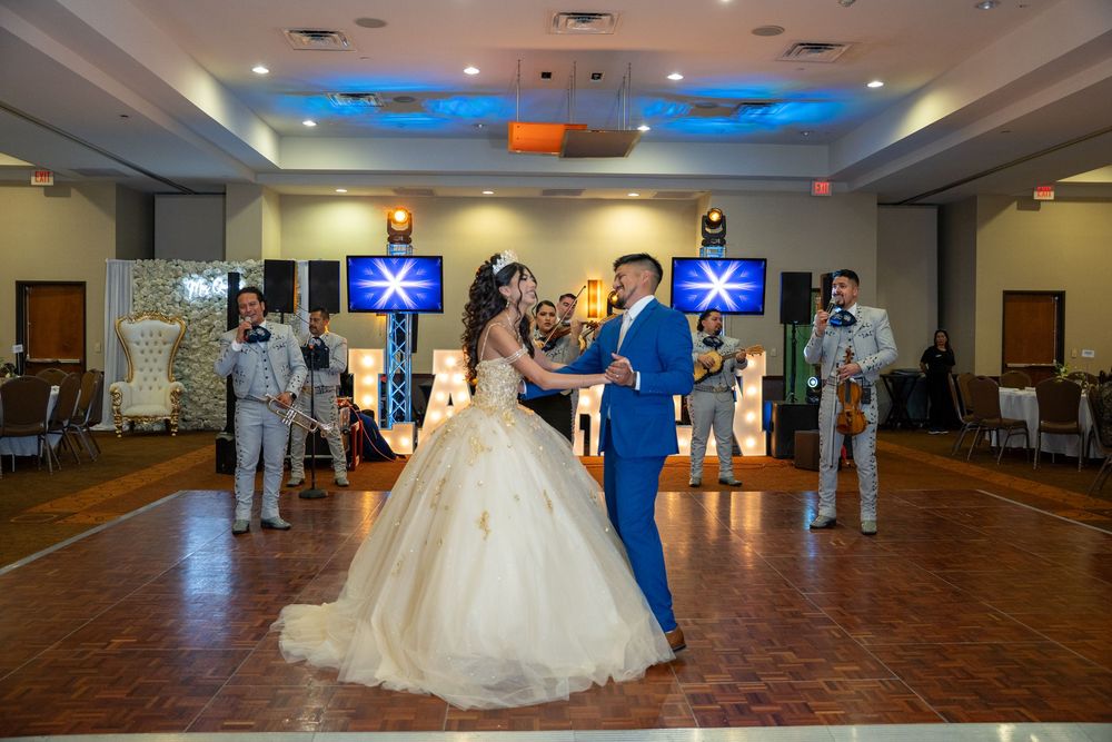 Quince reception dance floor with blue accent lighting and elegant decor.