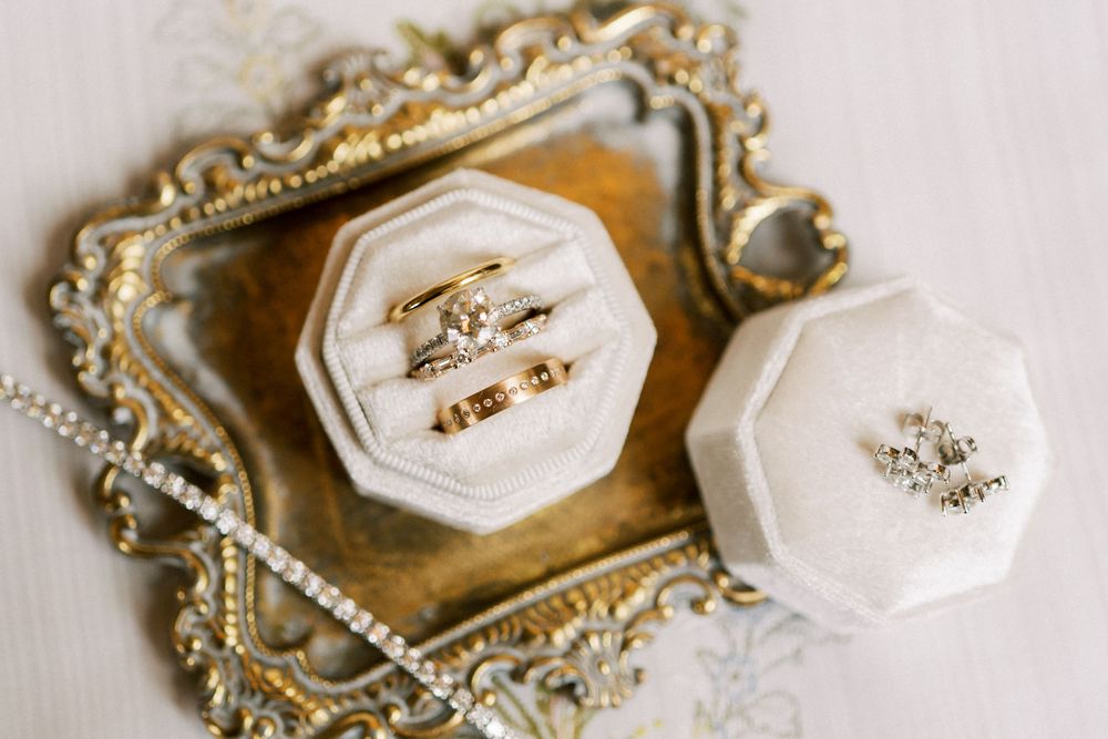 Silver antique-style jewelry box with mother of pearl lid and ornate metal frame displayed on elegant surface.