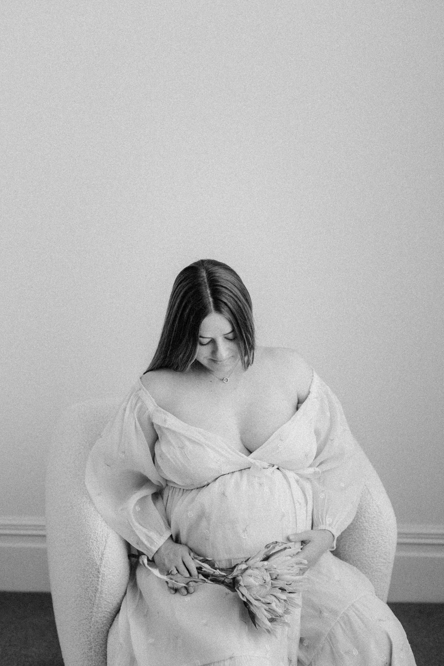 A black and white artistic series showing figure in white dress creating movement and emotion through different poses.