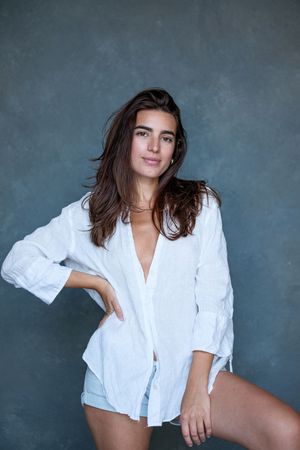 Fashion series in white button-down shirt with dramatic studio lighting.
