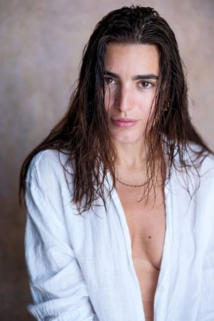 Artistic portrait series showing person in white bathrobe with wet hair against neutral backdrop.