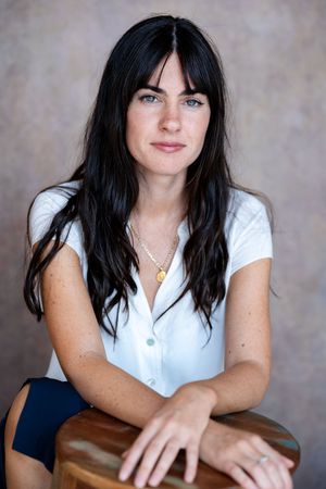 Professional headshots series with white button-down shirt against textured backdrop.