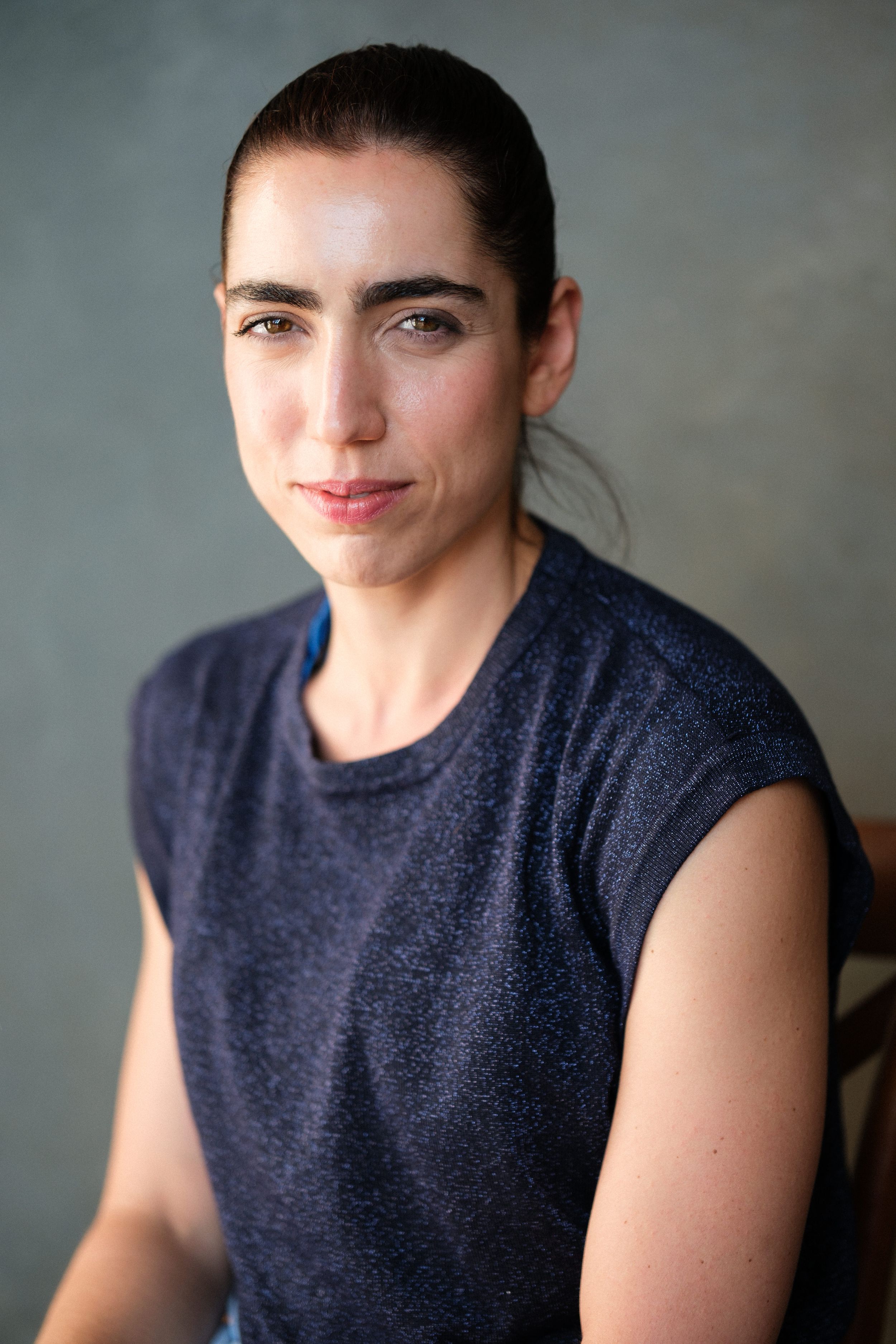 Close-up portrait sequence showing warm expressions in a navy sleeveless top.