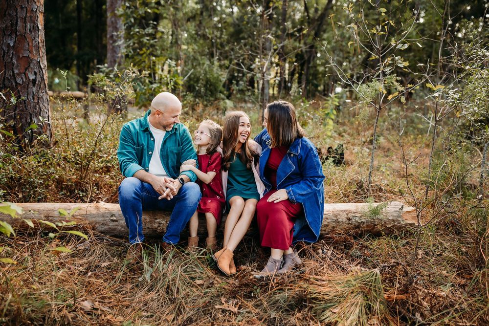 A collection of natural outdoor photo sessions showing people sitting on fallen logs and exploring wooded areas in autumn.