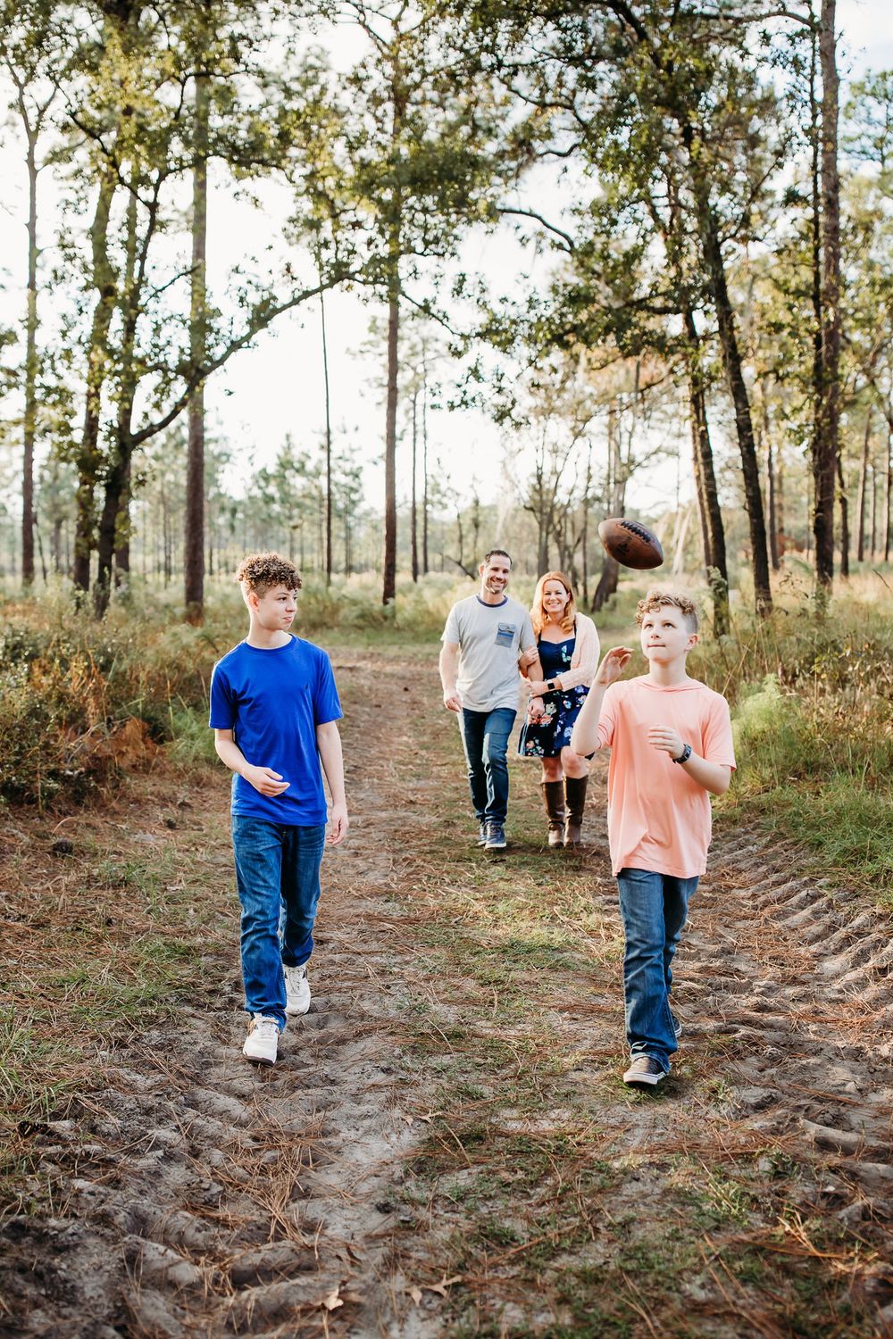 A series of candid photos showing children walking and playing together along a wooded dirt path on an autumn day.