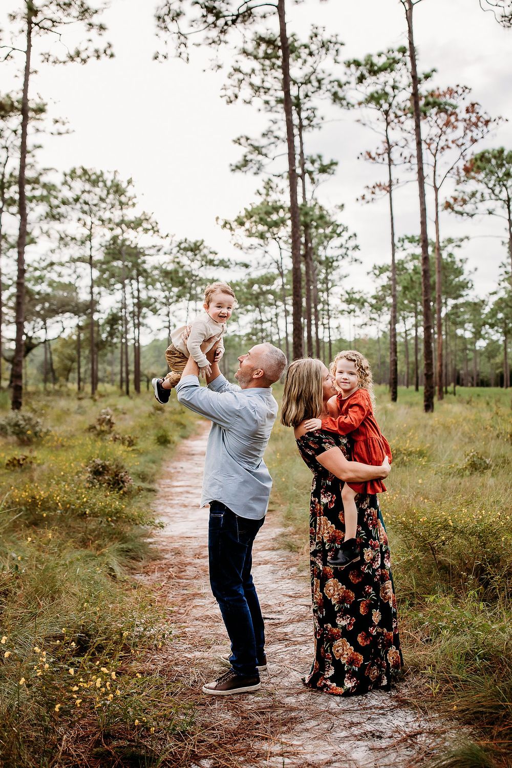 Three candid moments of a couple dancing and embracing together on a sandy path surrounded by pine trees.