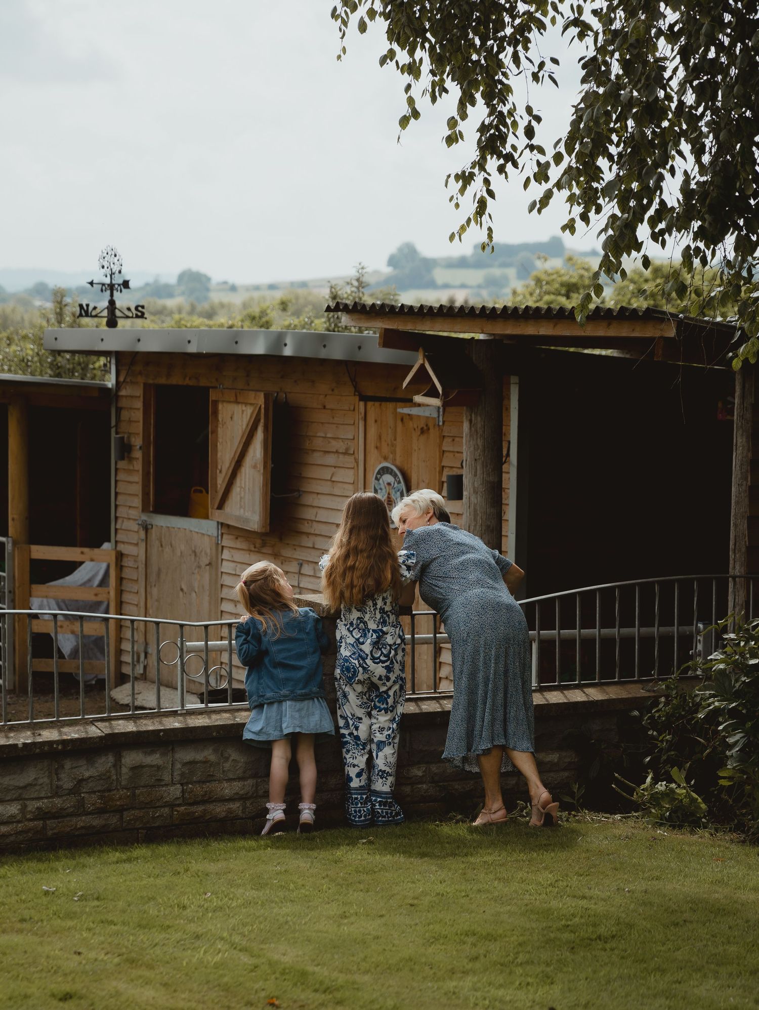 Multigenerational family photo, looking at the back garden chicken coops