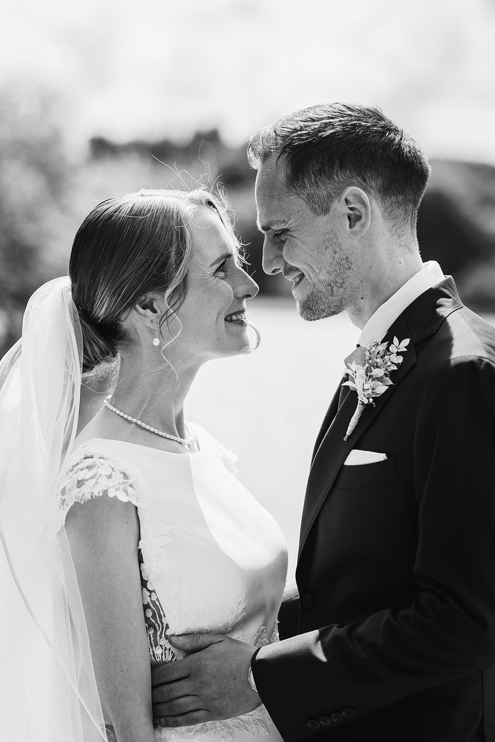 Black and white romantic wedding photos show tender moments between couples about to kiss.
