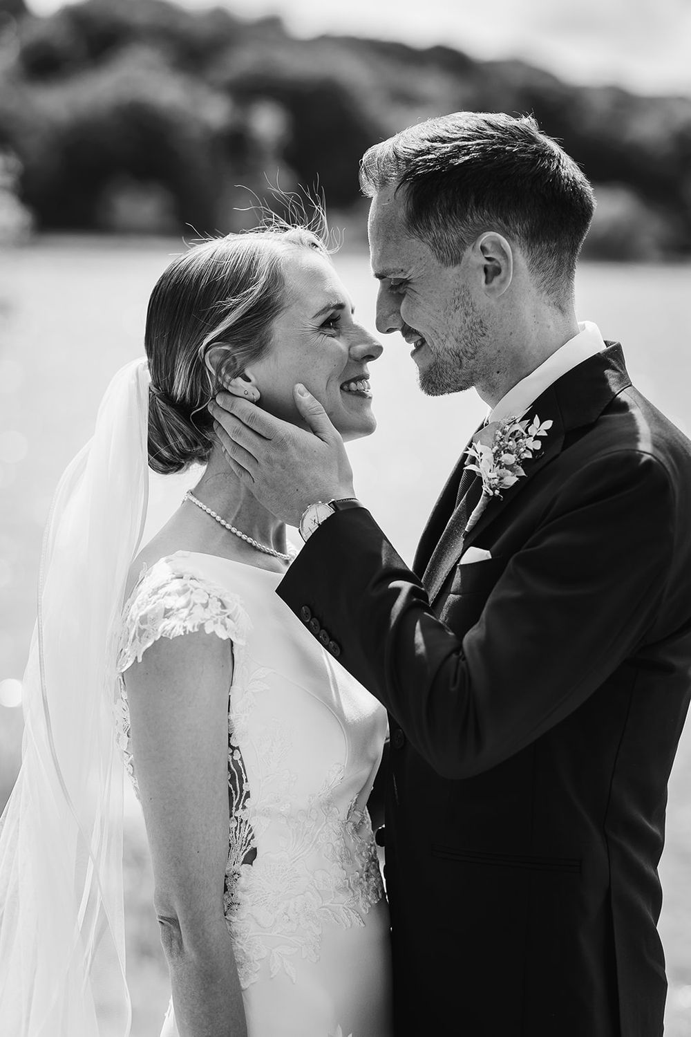 A romantic black and white wedding photo series showing tender moments between a bride and groom.