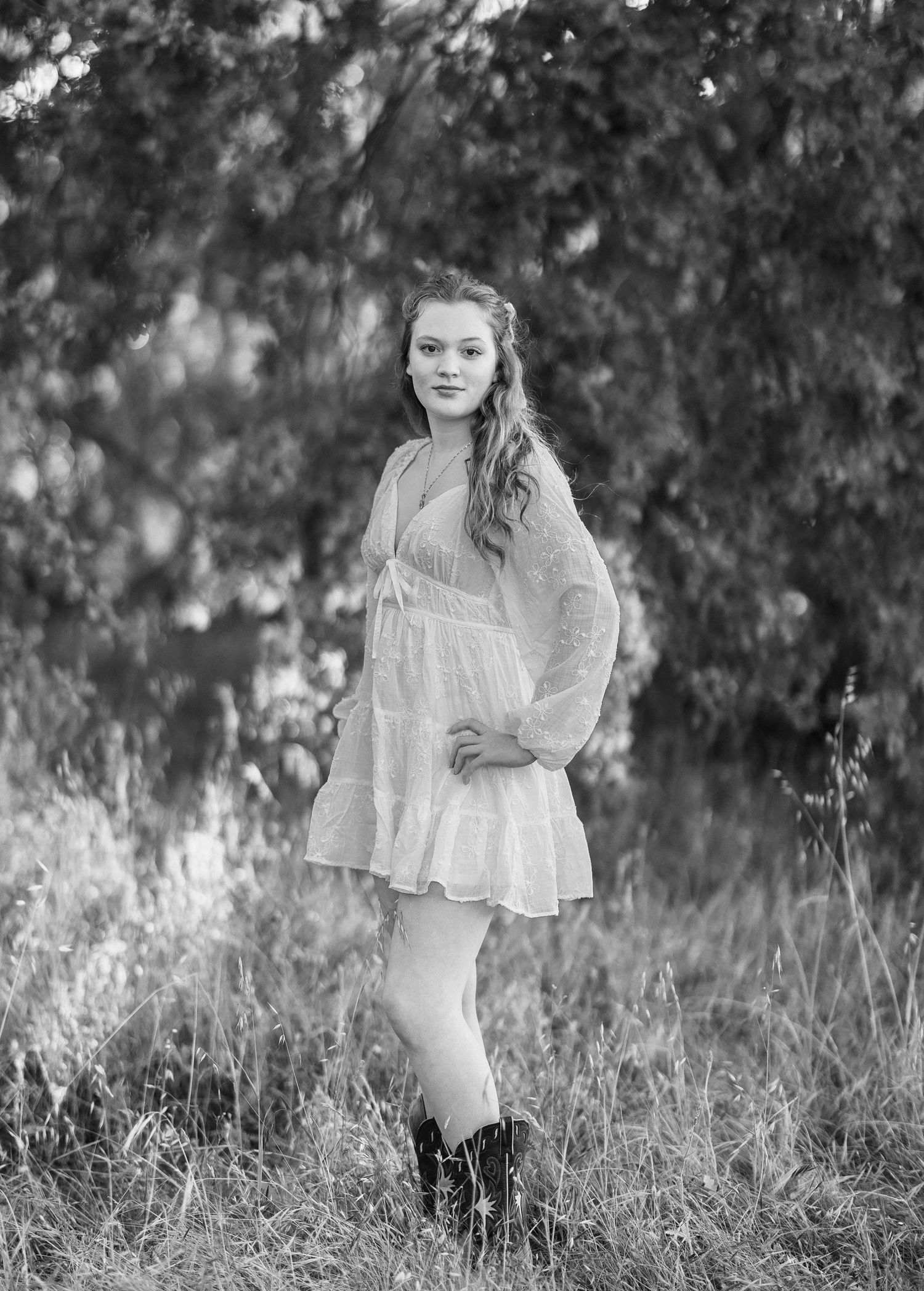 Ethereal portrait session in a meadow featuring a white lace dress and natural lighting.