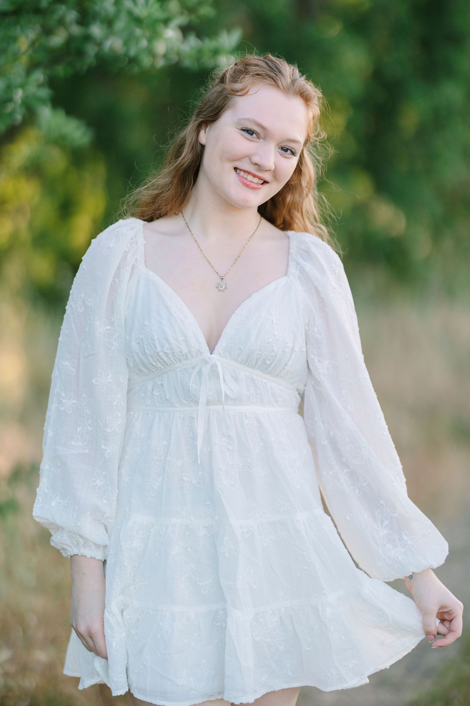 Romantic portrait collection featuring empire waist dress and natural outdoor backdrop.