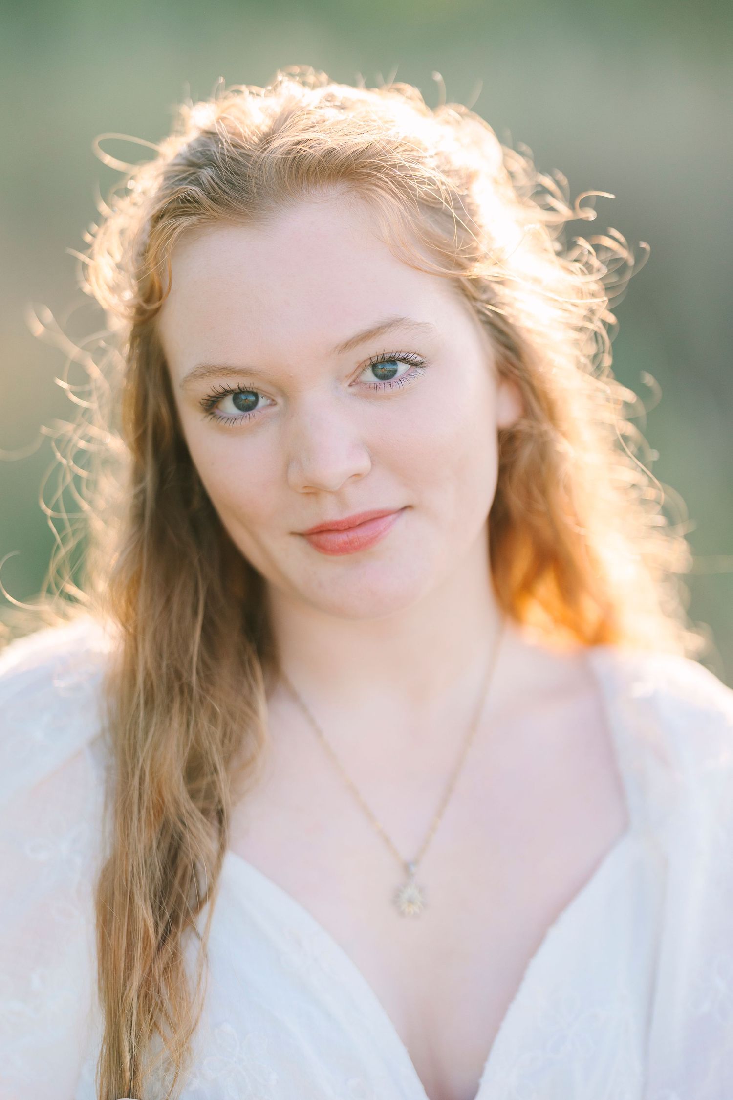 Sun-kissed close-up portraits with ethereal lighting and natural makeup.