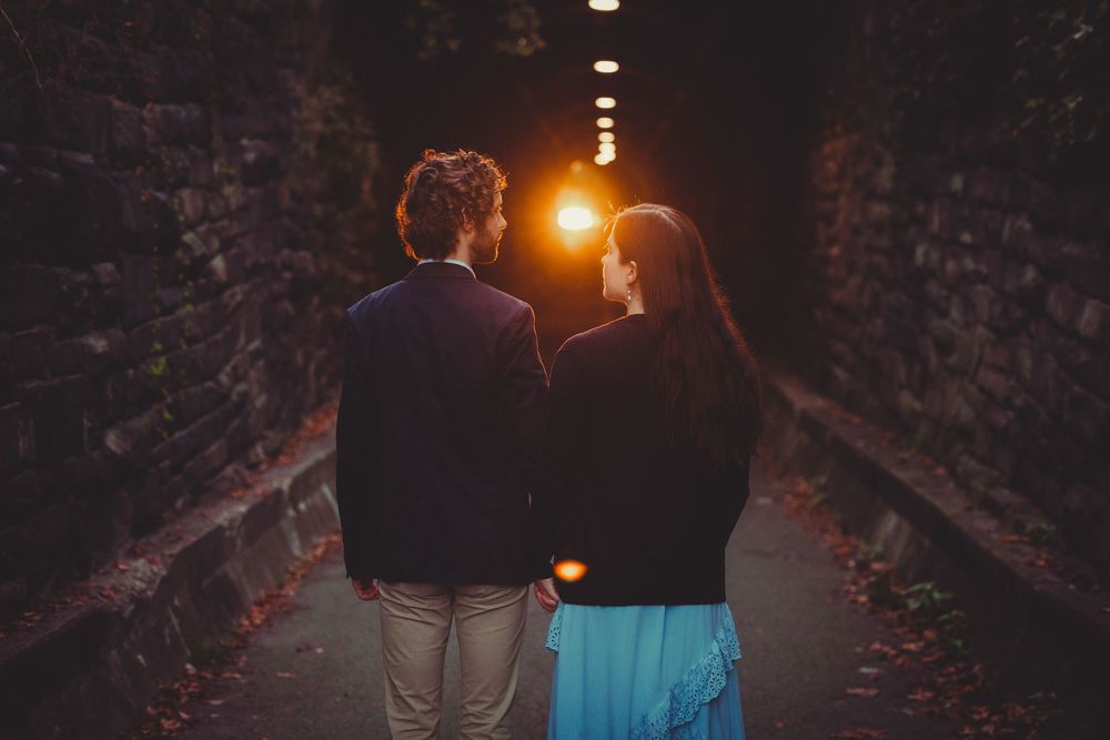 Golden sunrise light casting a romantic glow on couple during their Alexandria Waterfront engagement session