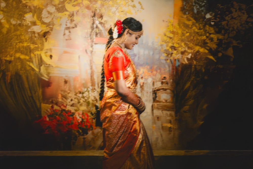 A performer in a red kimono dances gracefully against a golden backdrop during a traditional Japanese performance.