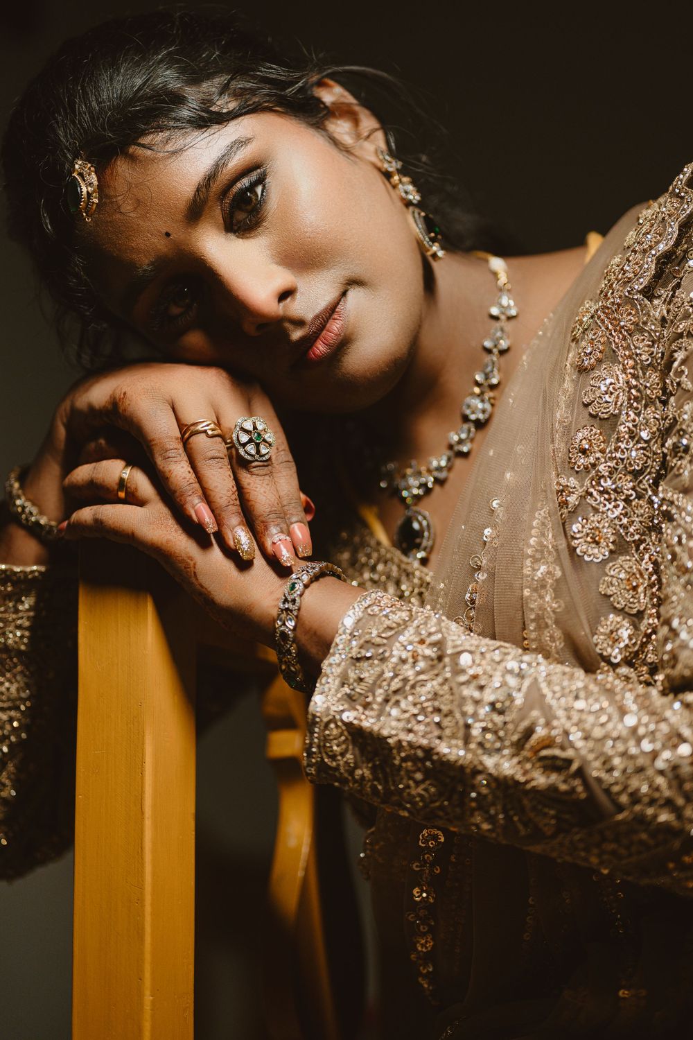 Elegant jewelry and sequined dress details shown in a series of moody, dramatic fashion portraits.