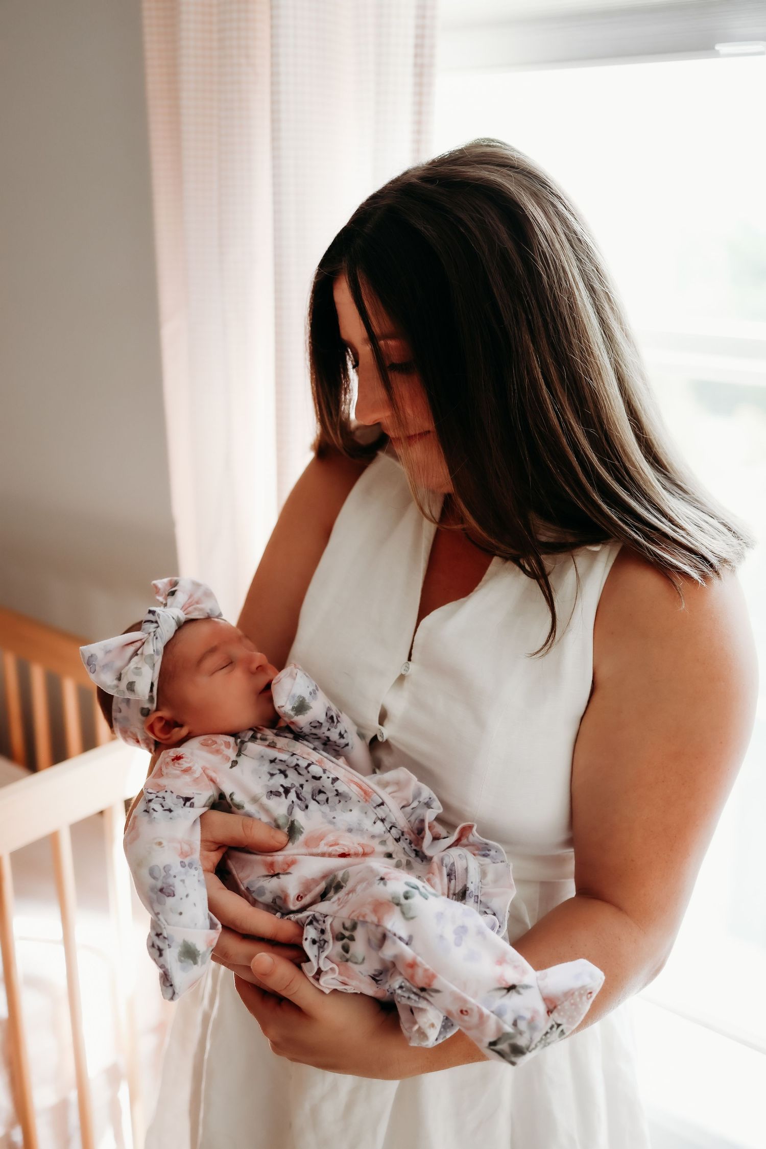 A series of tender moments between a parent and newborn baby in a bright, sunlit room with white curtains.