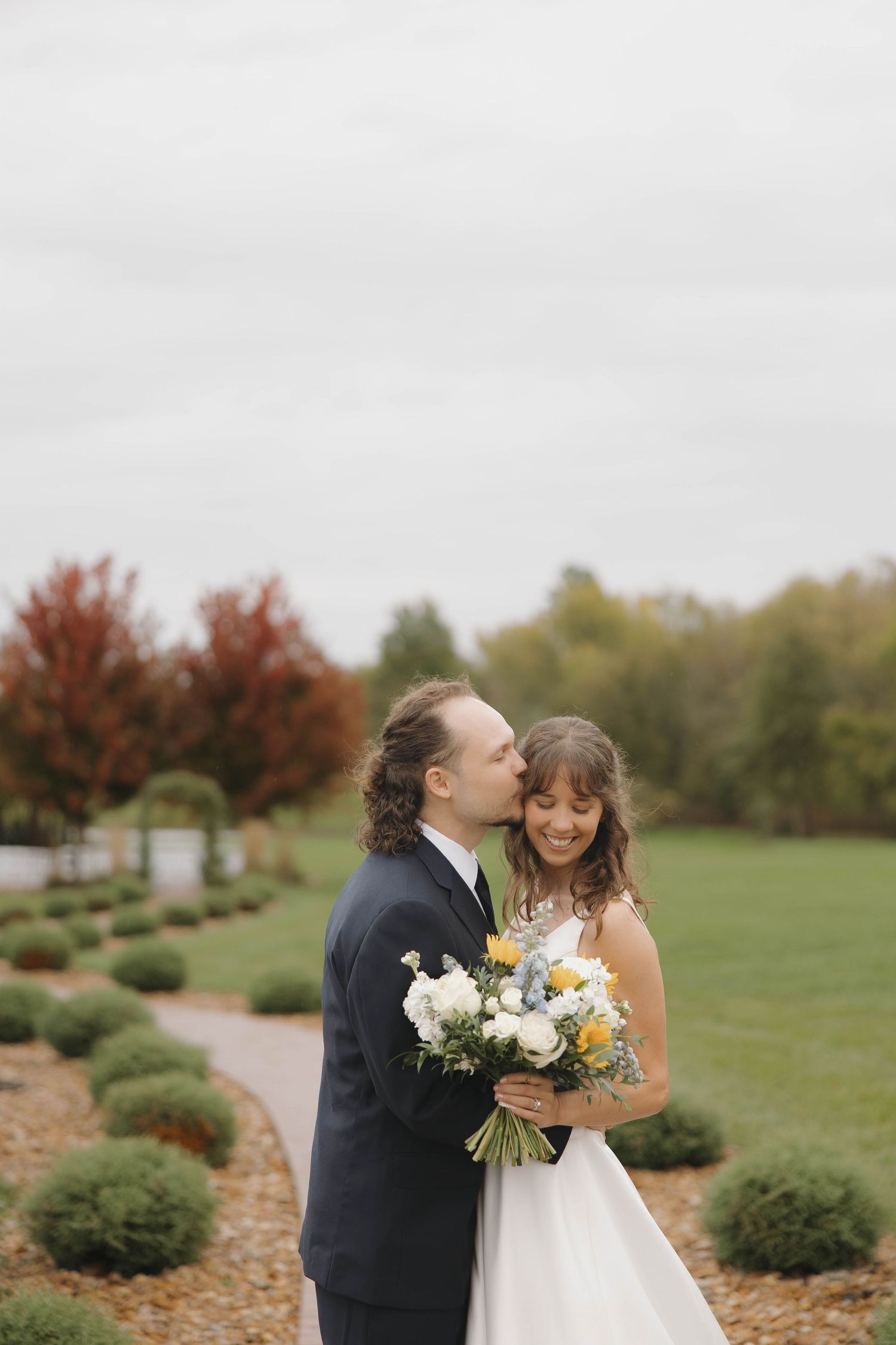 A romantic autumn wedding photo shoot in a garden with soft floral bouquets.