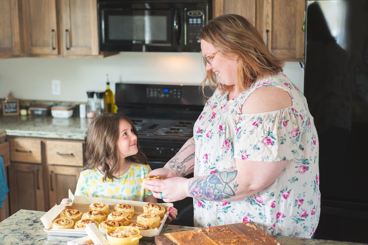 mom and daughter make cinnamon rolls