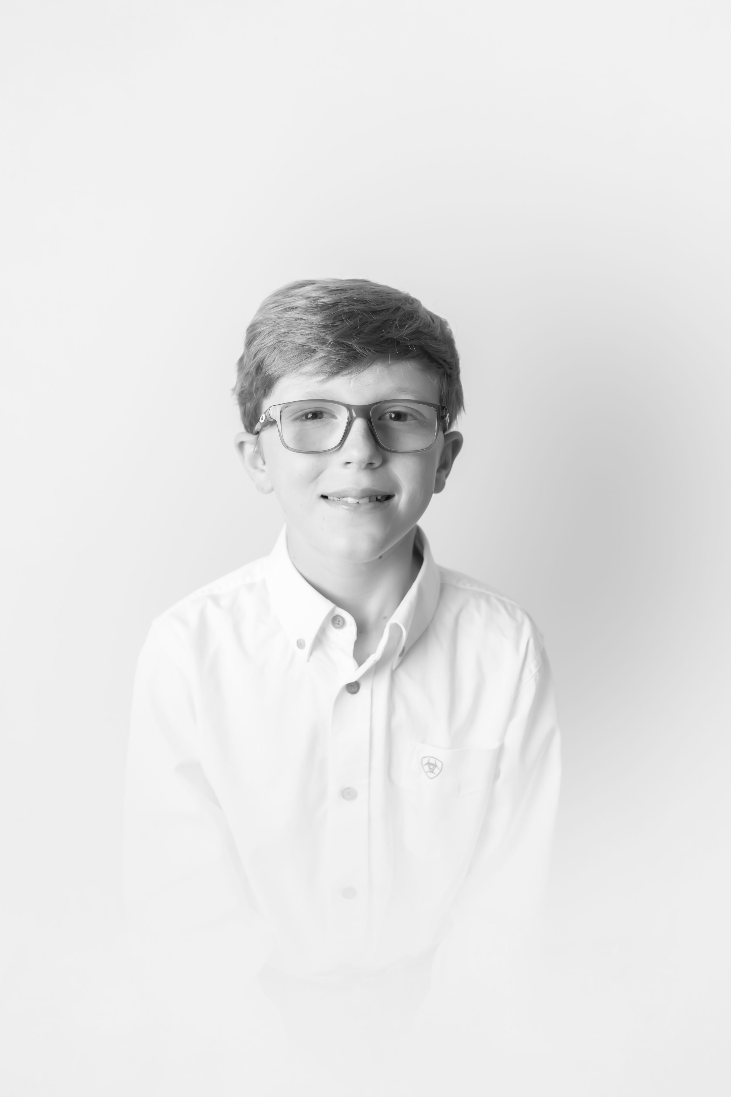 Black and white portrait sequence showing gentle smiles and glasses.