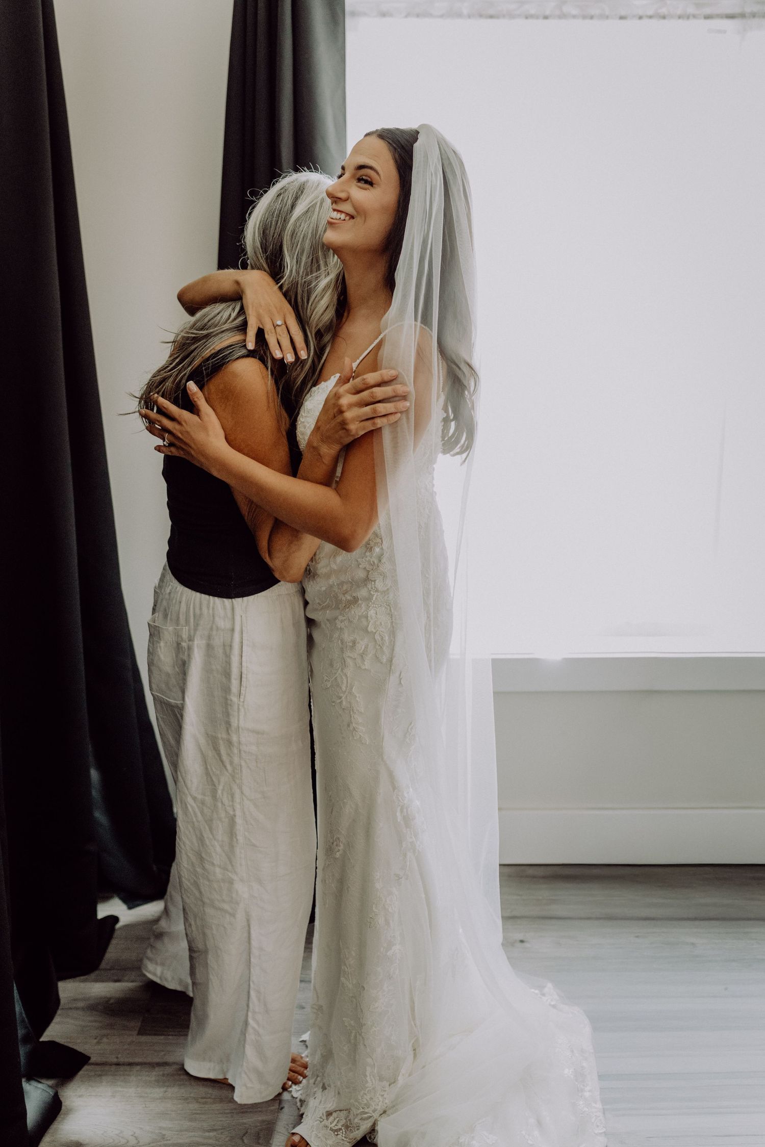 A series of emotional embrace photos showing a touching moment between two people in white and black attire.