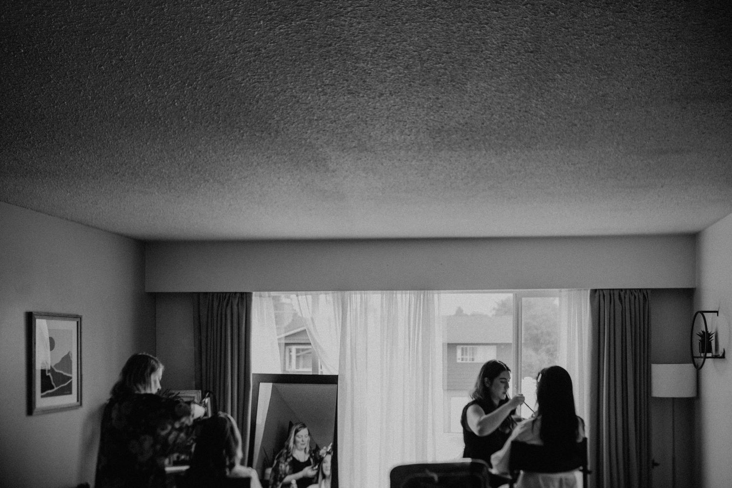 Black and white photo sequence showing people in a hotel room preparing and getting ready for an event.