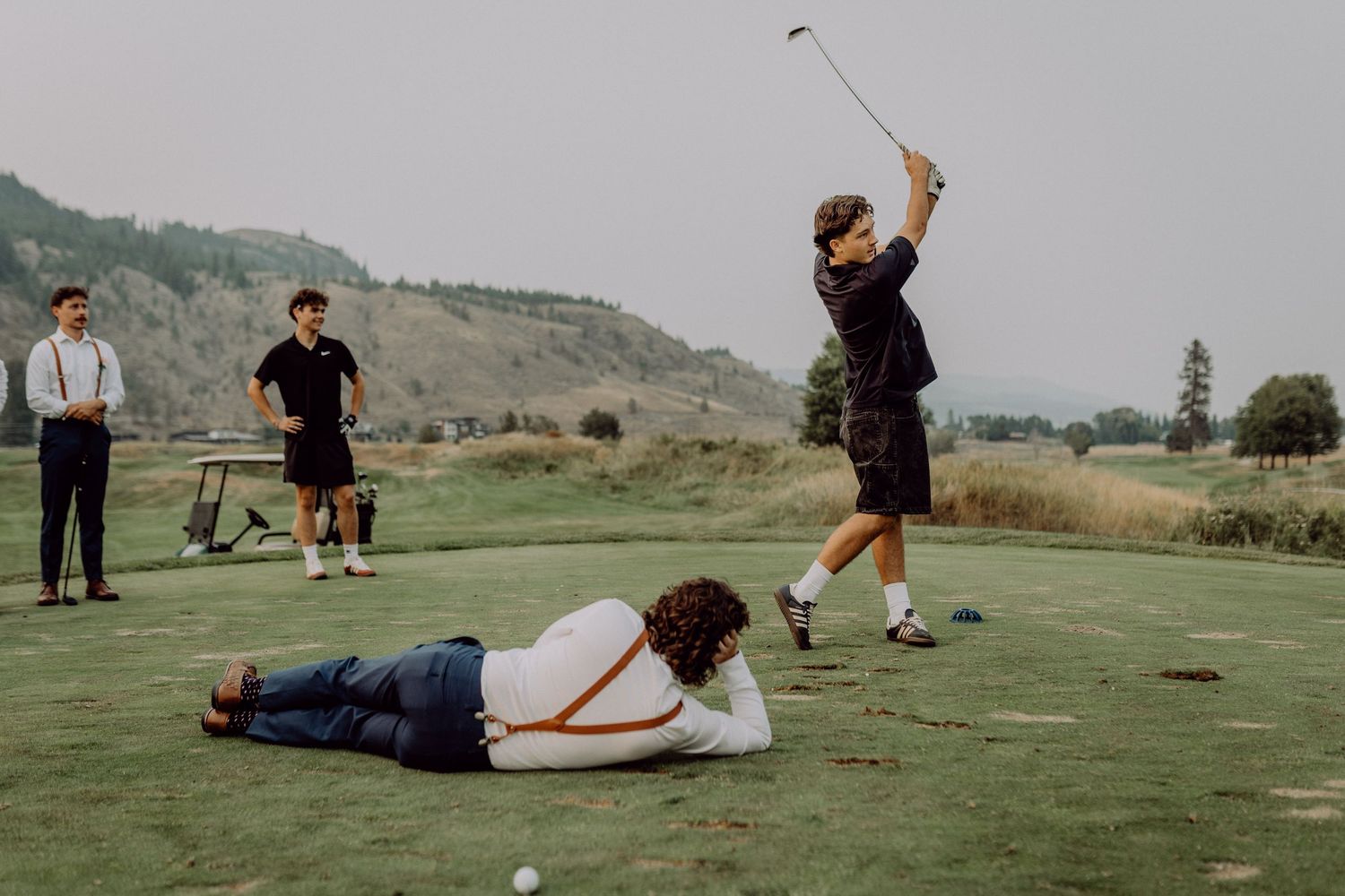 A sequence of golf swing motion shots showing a player's follow-through technique on a scenic course.