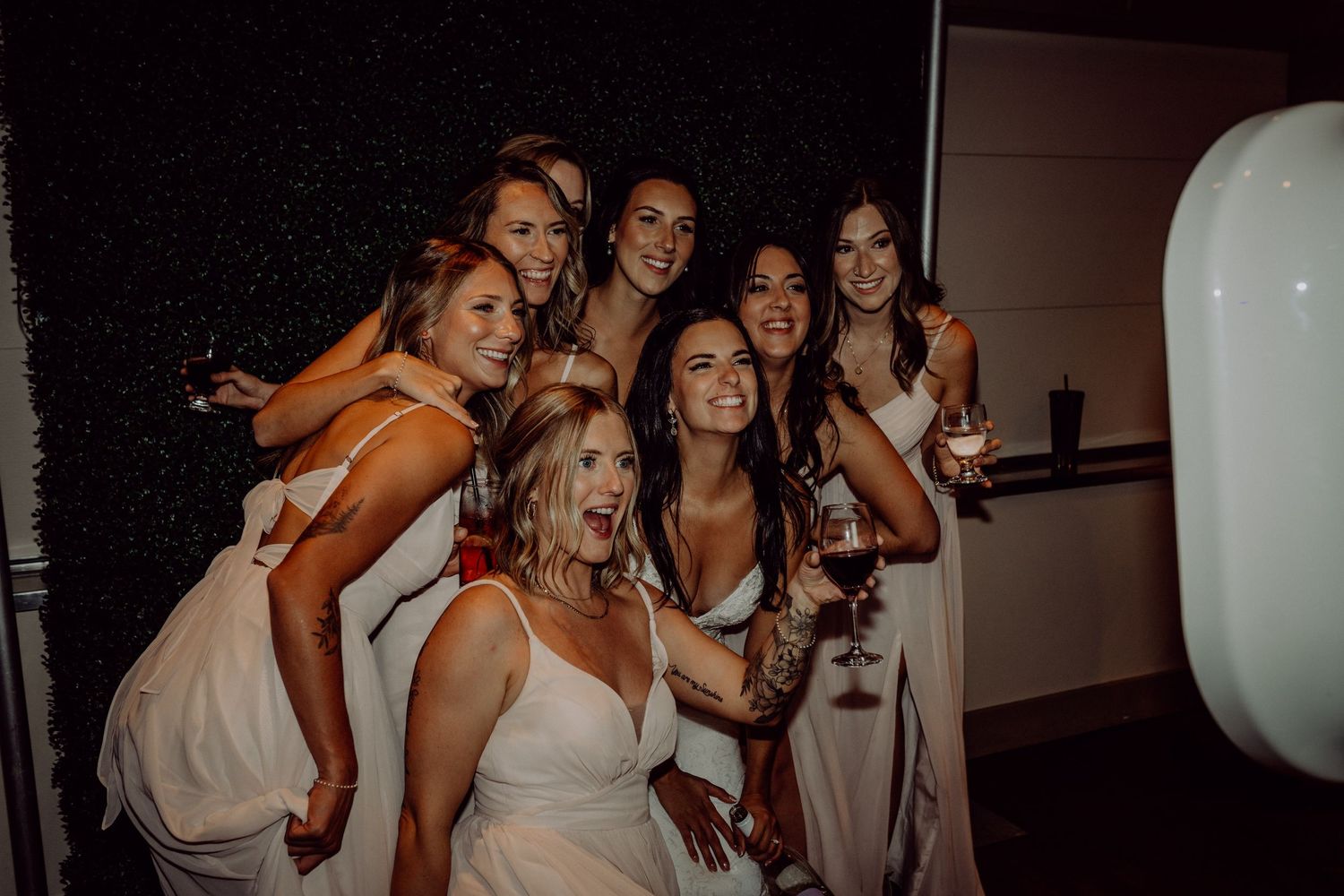 A group of people dancing and celebrating at a lively party in formal attire.