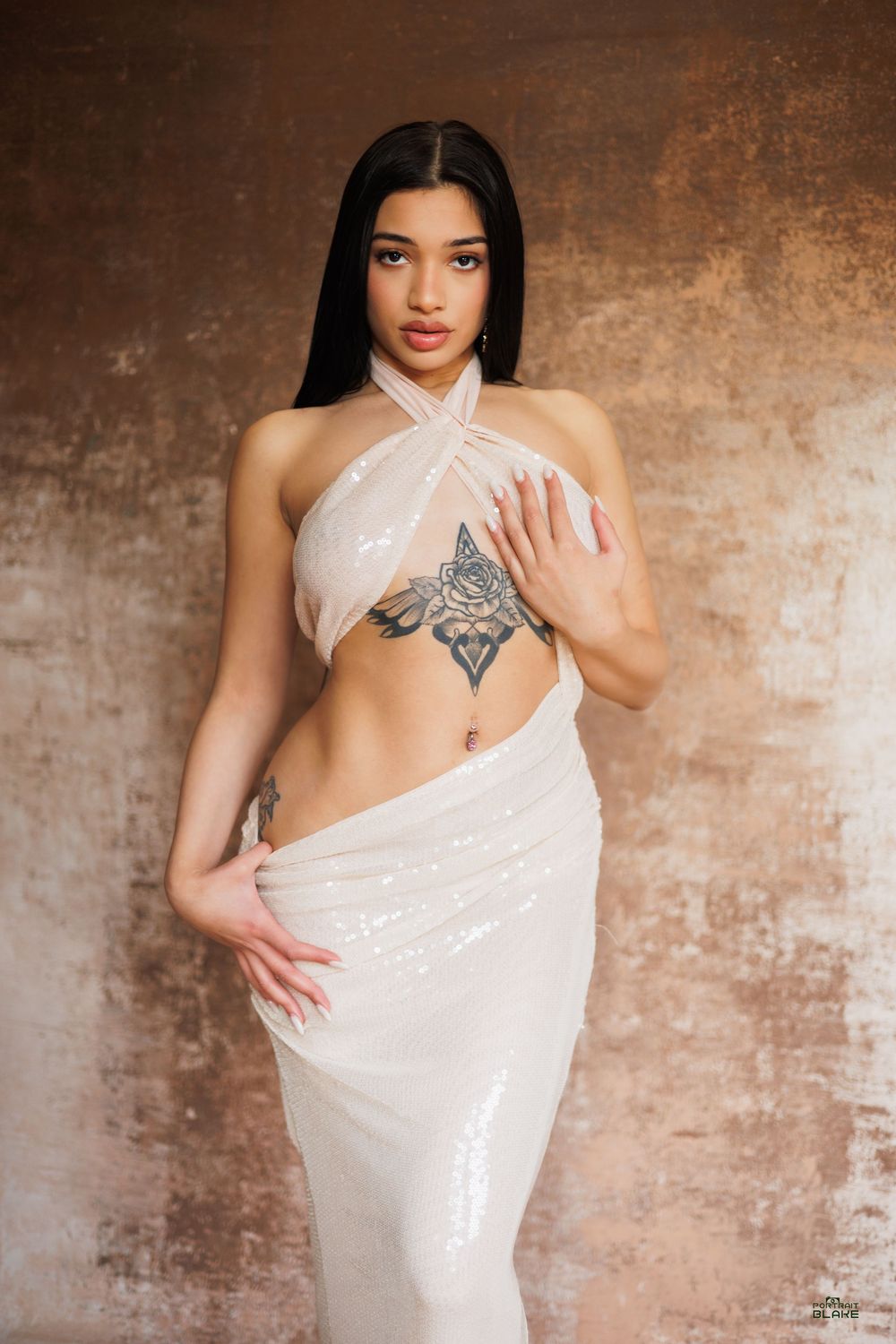 A figure in a white draped fabric poses gracefully against a textured brown backdrop in a series of artistic portraits.
