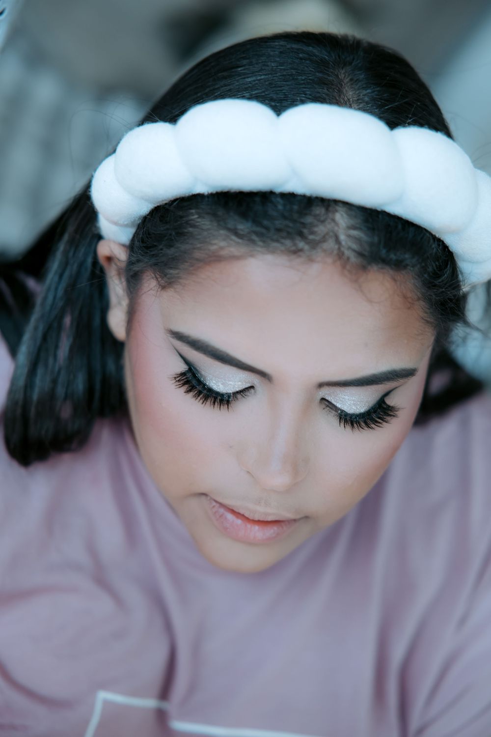 Close-up beauty shot showcasing delicate bridal makeup and long eyelashes.