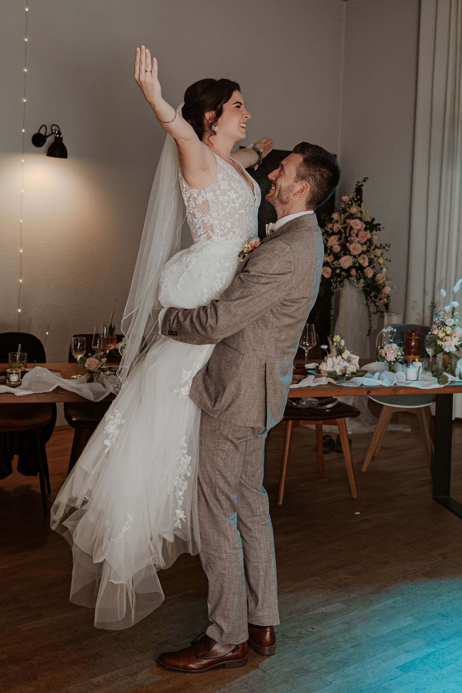 Intimate romantic couple sharing tender kisses in moody lighting with warm orange glow.