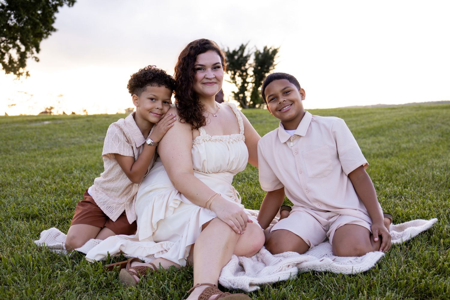 family sitting in grass