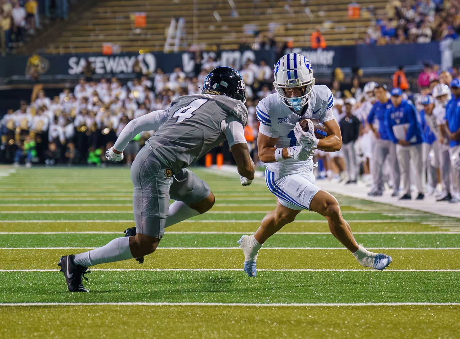Football players diving for a fumbled ball during an intense game play sequence.