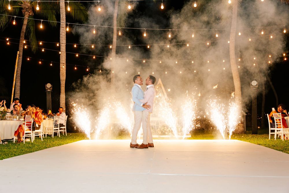 Spectacular fireworks display illuminates an outdoor evening celebration with bright white sparklers against the night sky.