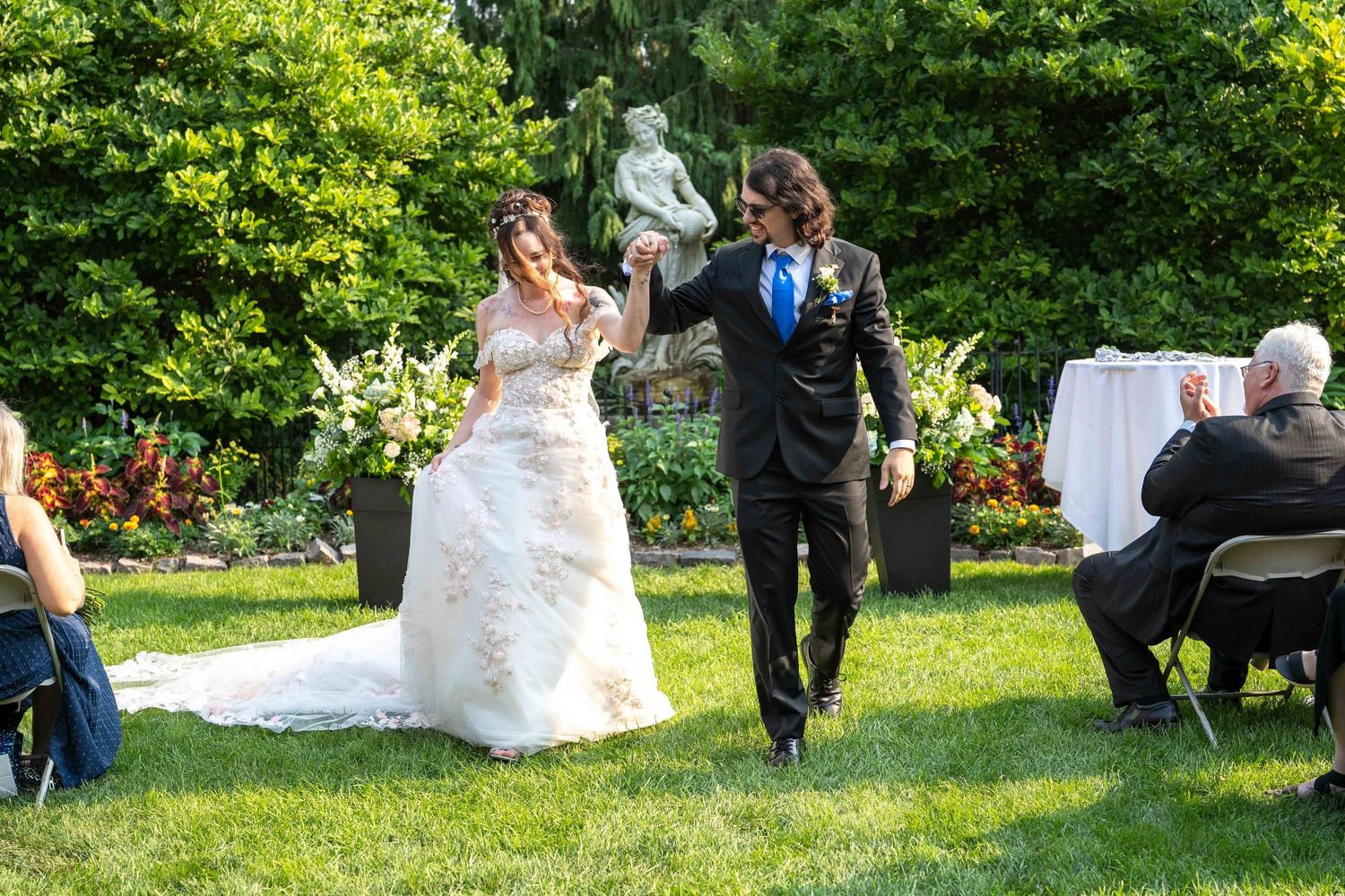 Bride and groom walk after ceremony in  greater Cleveland Aquarium
