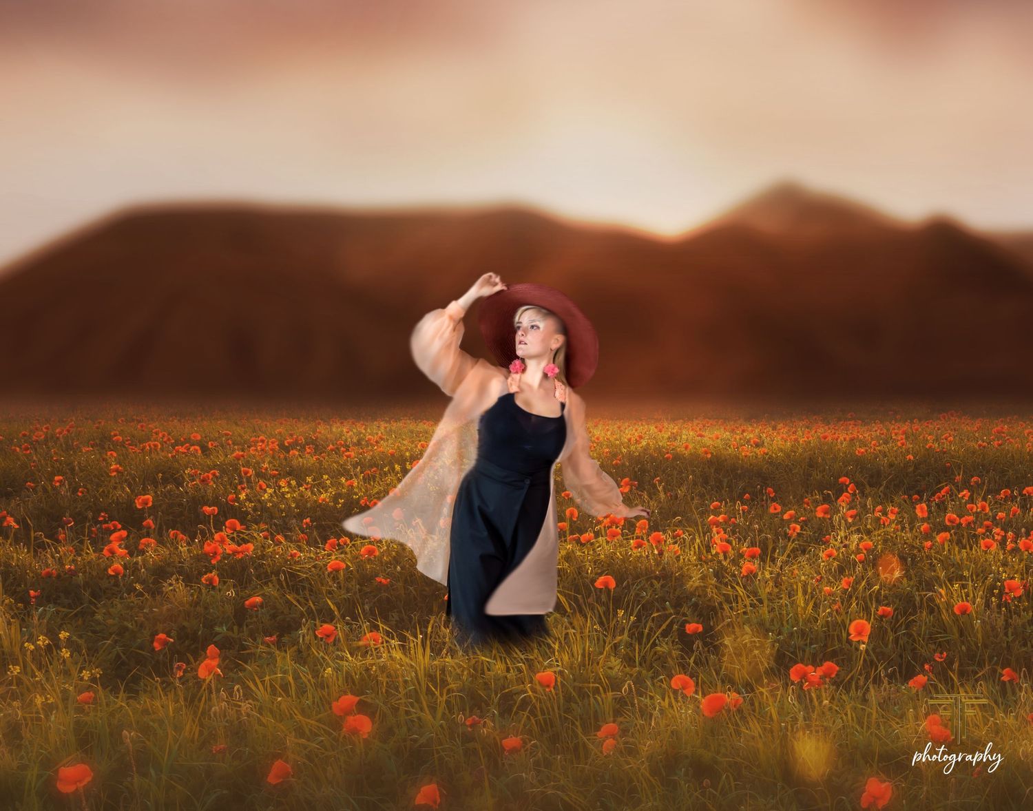 Woman in navy dress and red hat dancing in a vibrant poppy field at golden sunset with mountains.