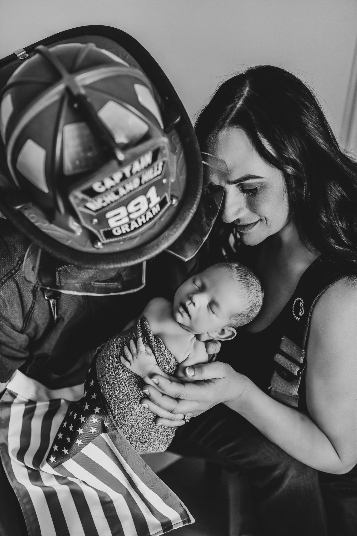 Firefighter family welcoming their newborn during a timeless studio photography session in Denton, Texas