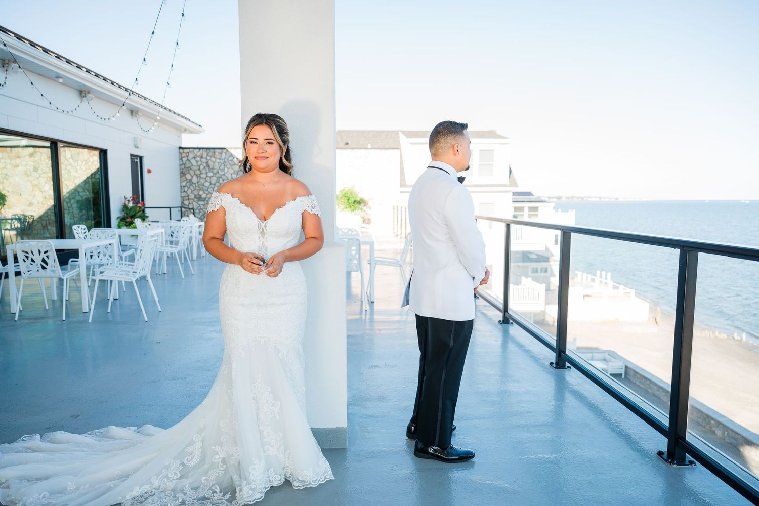 A collage of wedding photos showing a seaside venue with white decor and ocean views during a sunny day.