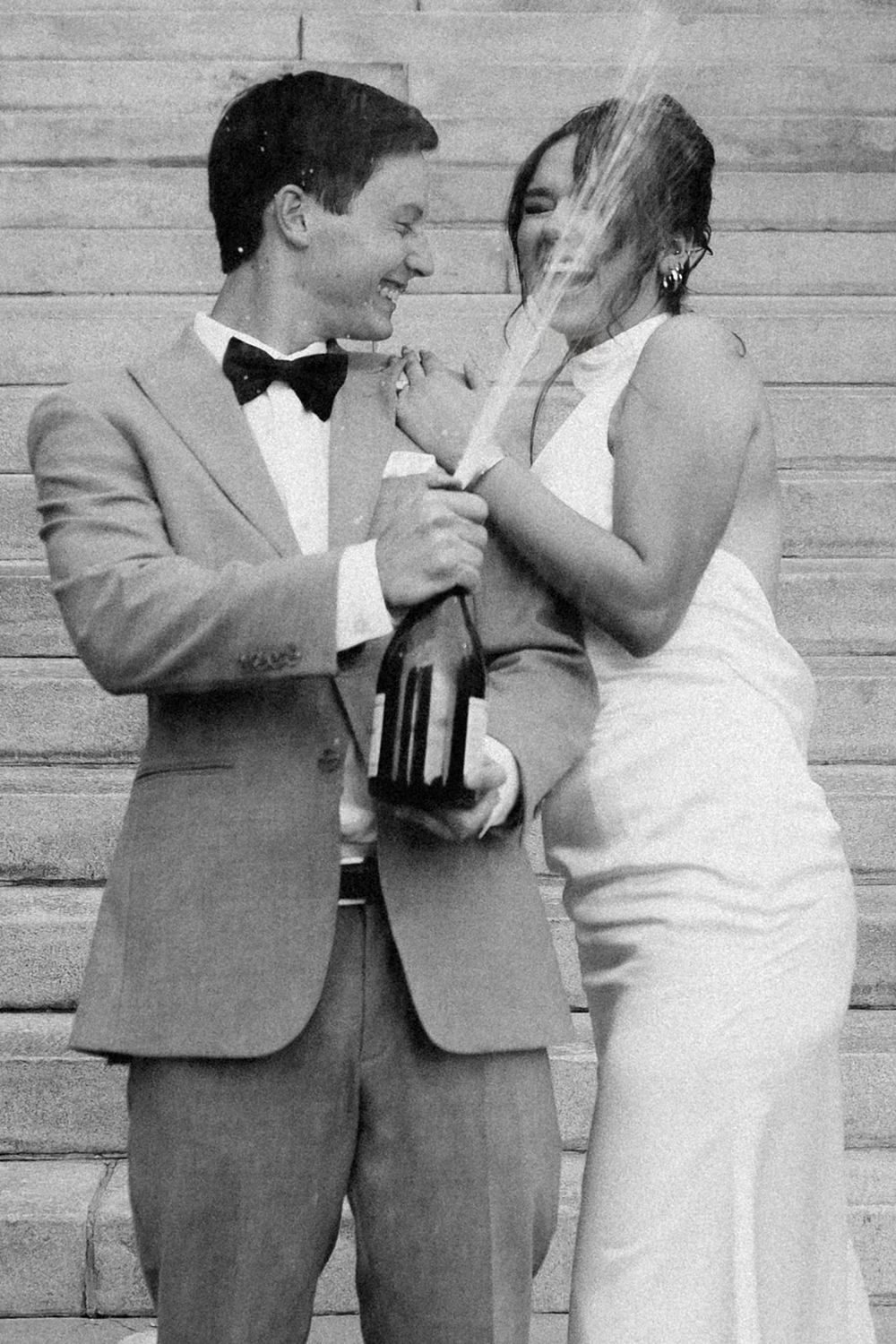 A romantic sequence of black and white wedding photos showing a couple embracing against a wooden wall background.