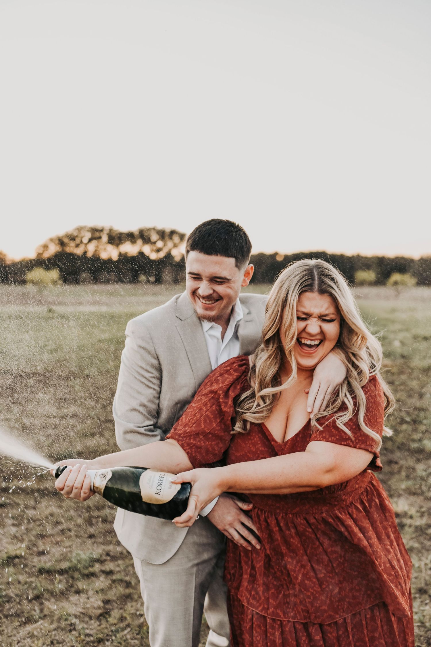 Engagement photos walking through field at Murrell Park Flower Mound.