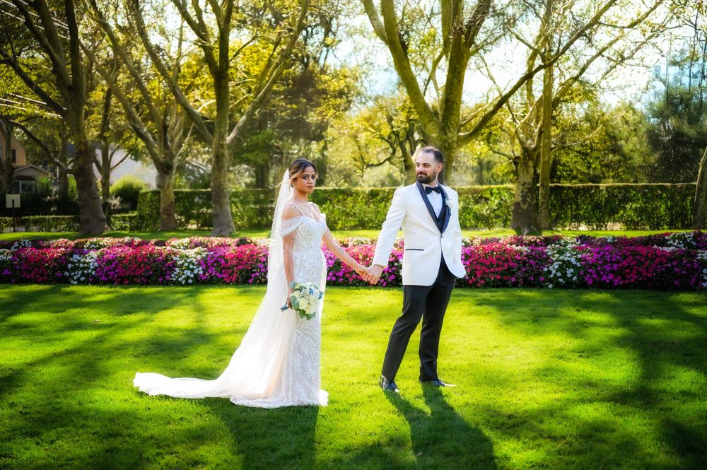 Wedding at Stewart Manor Country Club, Long Island, by Deja Vu Studios, with an elegant bride and groom portrait sunlight from behind