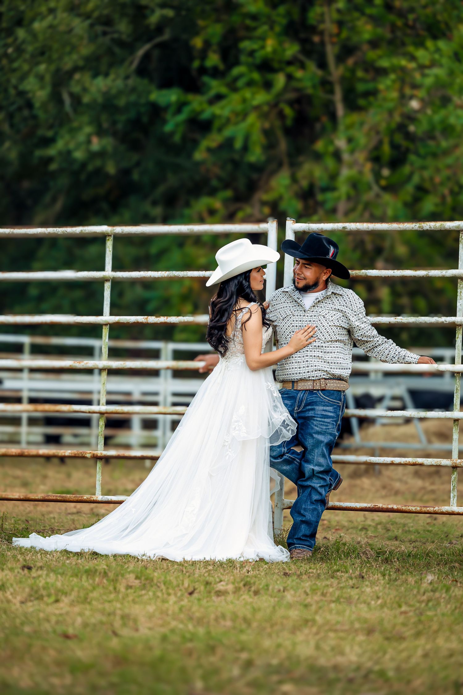 A sequence of wedding photos showing a couple playfully posing by a white fence on a grassy field.