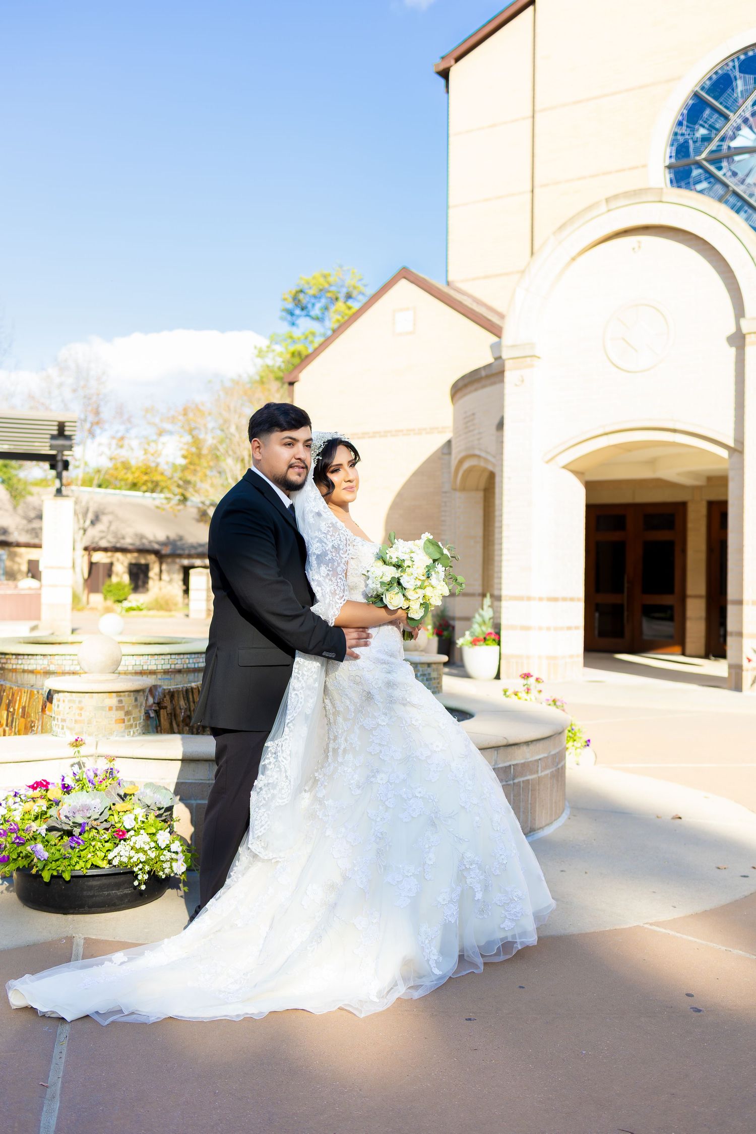 Wedding photo series capturing romantic moments outside a cream-colored church building.