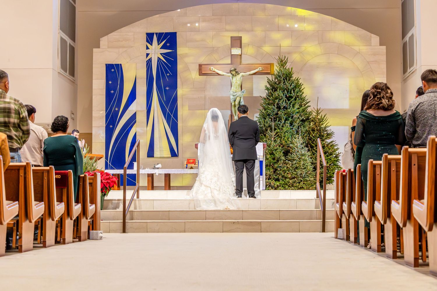 Interior view of a modern church sanctuary with wooden pews and Christmas decorations during a holiday service.