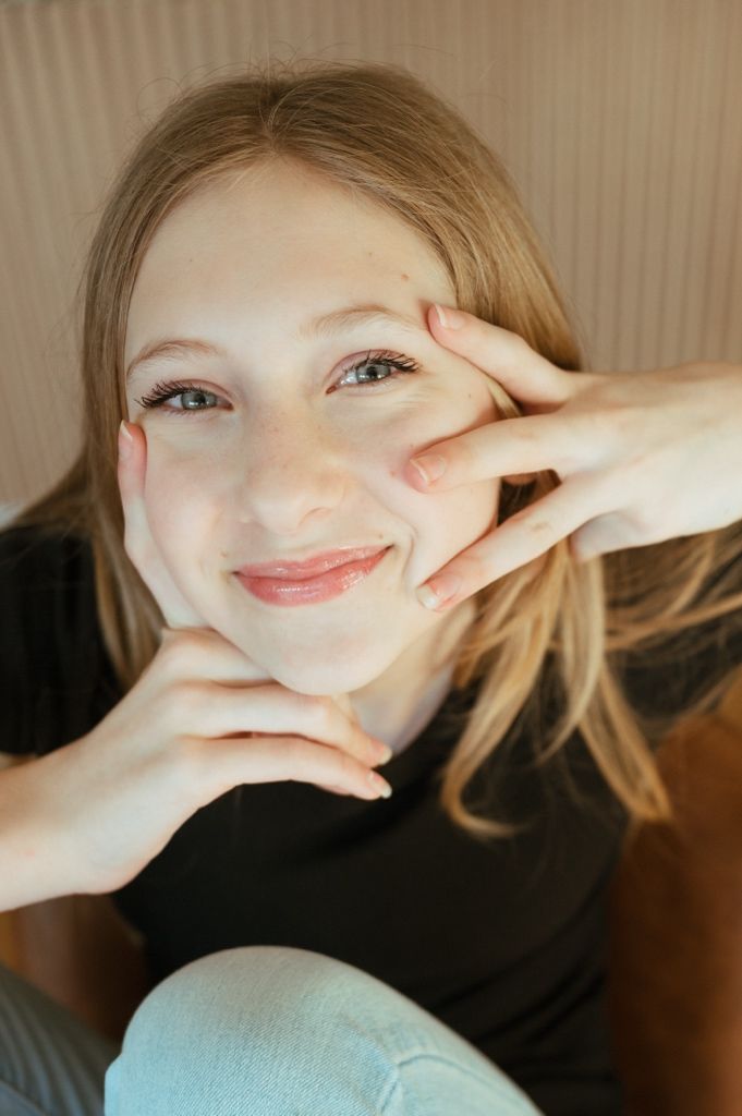 Artistic portrait sequence showing playful hand poses and expressions in natural lighting.