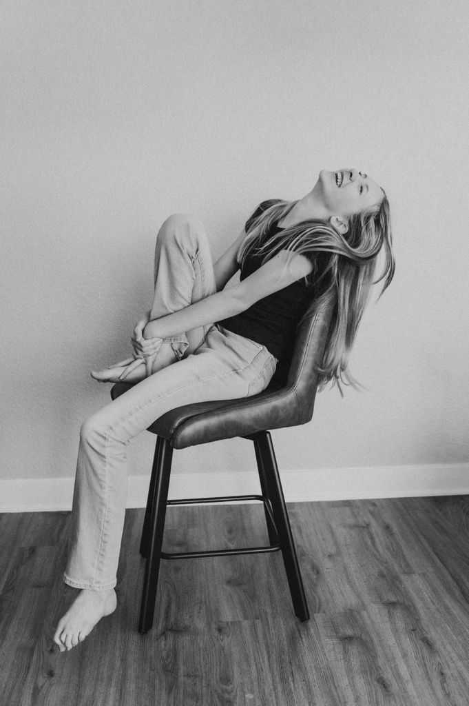 Black and white photo series showing dramatic poses on a wooden chair.